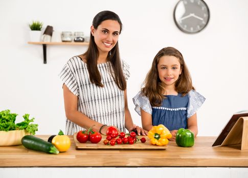 Shot of a mother and daughter having fun in the kitchen