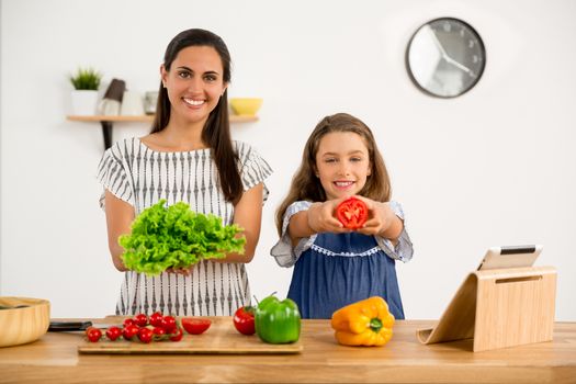 Shot of a mother and daughter having fun in the kitchen