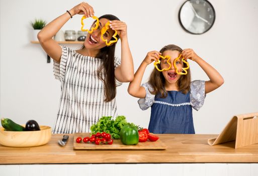 Shot of a mother and daughter having fun in the kitchen