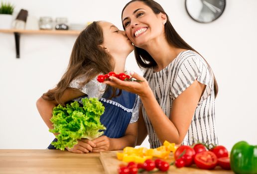 Shot of a mother and daughter having fun in the kitchen