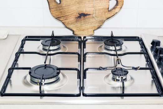 Kitchen stove top with a wooden plate