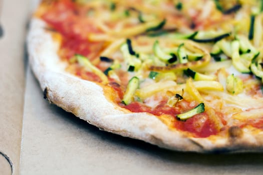 Close up of a tasty pizza with zucchini and potatoes