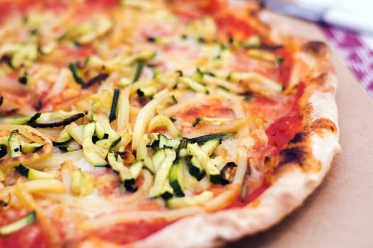 Close up of a tasty pizza with zucchini and potatoes