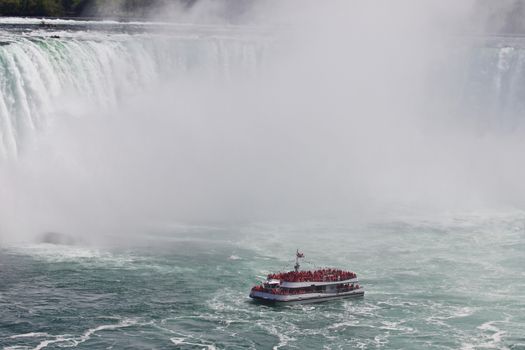 Beautiful photo of a ship near amazing Niagara waterfall