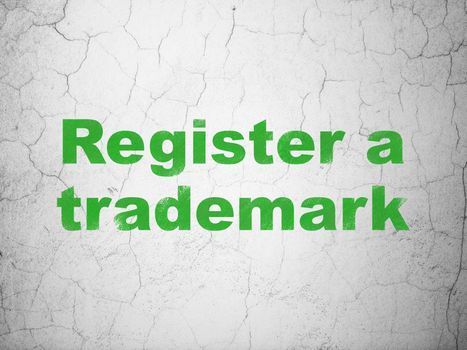 Law concept: Green Register A Trademark on textured concrete wall background