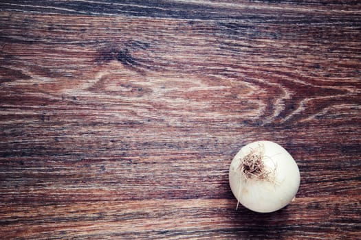 onion on wood. Top View on wooden table with Copy Space. Ingredients for cooking