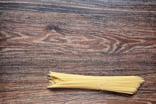 spaghetti on wood. Top View on wooden table with Copy Space. Ingredients for cooking