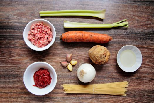 Ingredients for spaghetti bolognese on wooden background. Vegetables on wood. Top View on wooden table