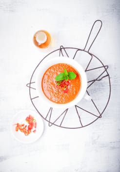 Bowl of fresh tomato soup gazpacho on the table