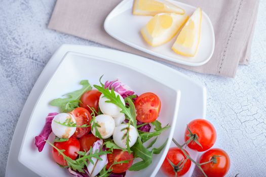 Fresh mozzarella balls served with spicy rocket leaves and cherry tomatoes.