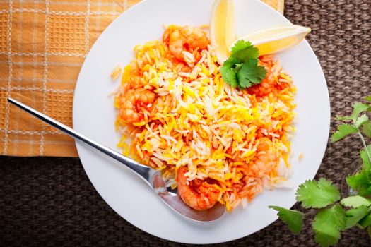 Indian Biryani with Shrimp and lemon on a table