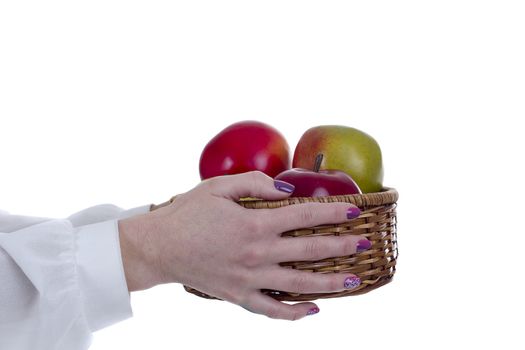 Basket with ripe fruit in female hands