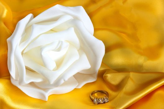  wedding rings on  a yellow fabric background