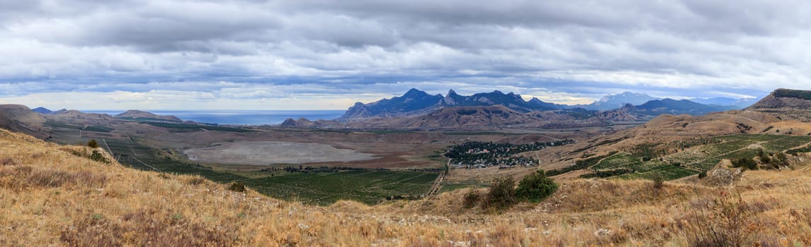 Running storm clouds on a background of mountains. Panorama