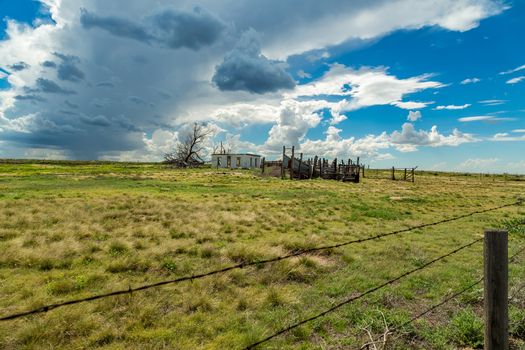 An empty building sits abandoned as a summer storm approaches near the Colorado Kansas state line on Us Highway 50.