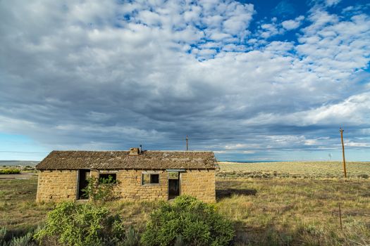 A stone building sits abandoned in the high desert of New Mexico