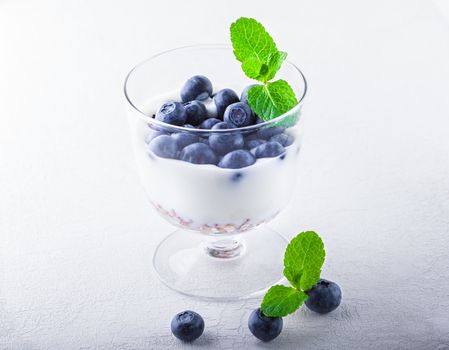 Yogurt with fresh blueberry and muesli in a glass