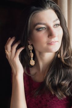 close-up portrait of a beautiful girl. She touching her hair