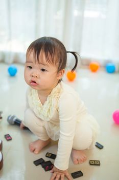 Happy little asian girl with microphone in the home