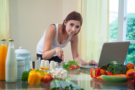 Young asian woman looking for a recipe on the internet