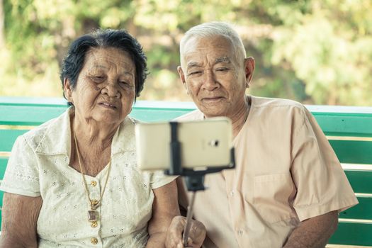 Black and white image of Happy senior couple posing for a selfie at home