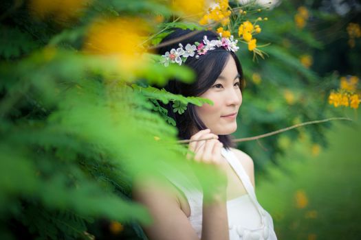 Beautiful asian young woman with a crown of flowers