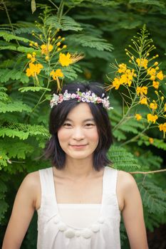 Beautiful asian young woman with a crown of flowers