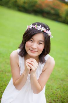 Beautiful asian young woman with a crown of flowers