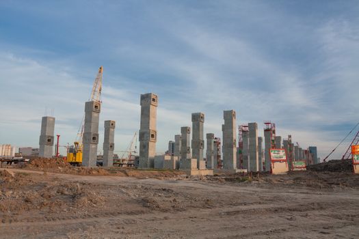 The construction site. Construction of the new building. Construction cranes.