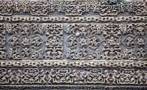 Old stone carvings on the wall temple in Myanmar