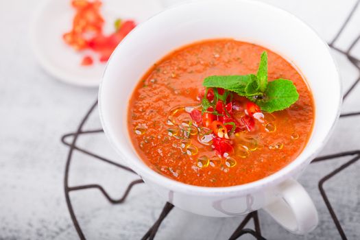 Bowl of fresh tomato soup gazpacho on a table