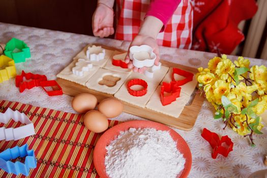 Girl hands making biscuits from dough