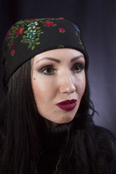 Portrait of a young gypsy woman on a black background