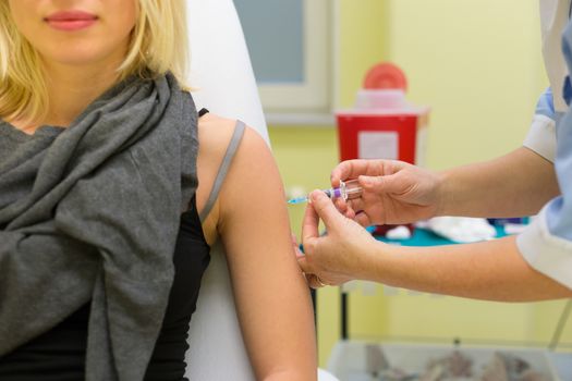 Preventive vaccination against virus infection. Nurse giving vaccination to a woman. 
