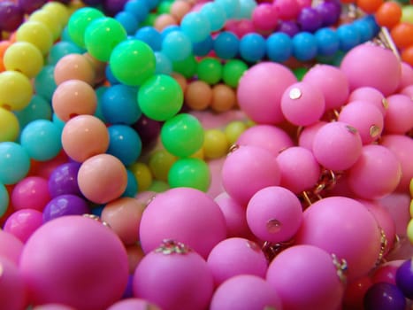 A colorful background of plastic beads in various colors.