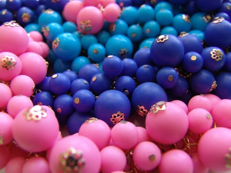 A colorful background of plastic beads in various colors.