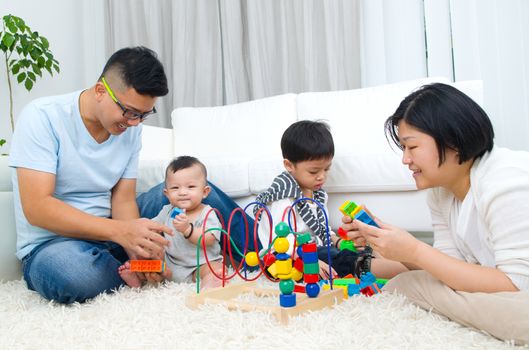 Asian family playing toys