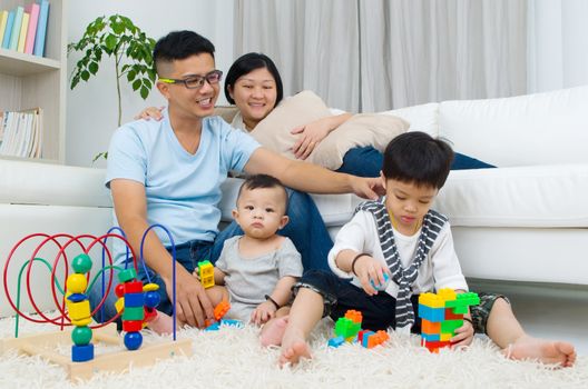 Asian family playing toys