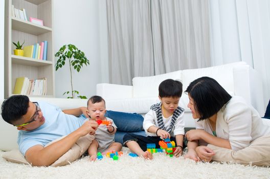 Asian family playing toys