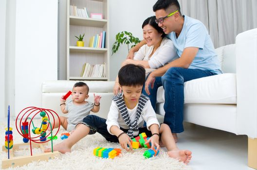 Asian family playing toys