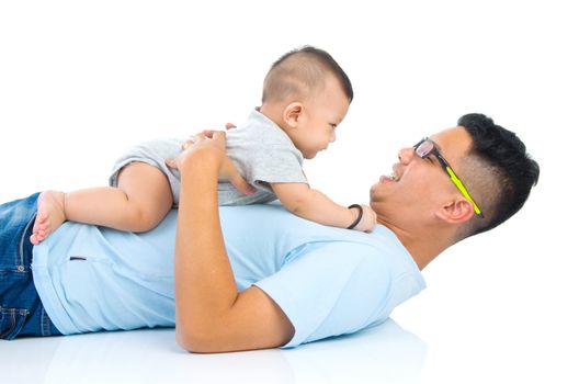 Asian father playing with baby boy