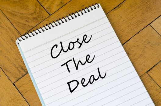 Close the deal text concept write on notebook