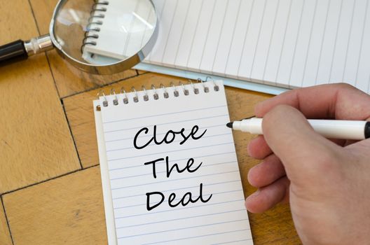 Close the deal text concept write on notebook