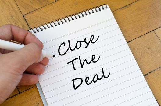 Close the deal text concept write on notebook