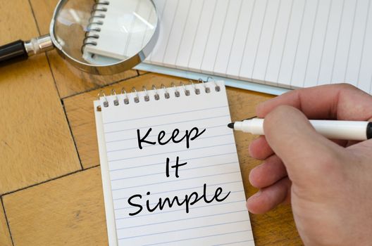 Keep it simple text concept write on notebook