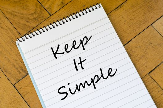 Keep it simple text concept write on notebook