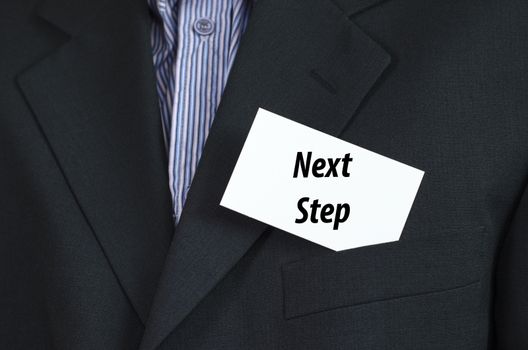 Next step text note concept over businessman background