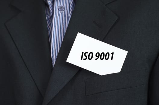 Iso 9001 text note concept over businessman background