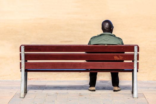 Black male sitting on a bench