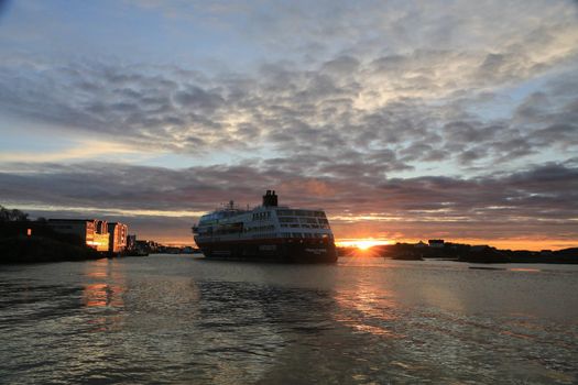 Ms Trollfjord ankommer Brønnøysund ved solnedgang